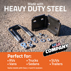 Black heavy-duty steel mounting brackets and hardware displayed on asphalt, with promotional text reading 'Made with HEAVY DUTY STEEL' and 'Perfect for: RVs, Vans, Trucks, Sedans, SUVs, Trailers.' A 'USA COMPANY' logo appears in the lower right.