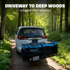 A white vehicle on a forest road with a large black and blue Mockins cargo bag strapped to the rear rack, with the text 'DRIVEWAY TO DEEP WOODS a rugged hitch solution' at the top.