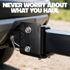 Close-up of a black hitch receiver with silver bolts and a tongue, mounted on a vehicle. Large white text at the top reads 'NEVER WORRY ABOUT WHAT YOU HAUL.